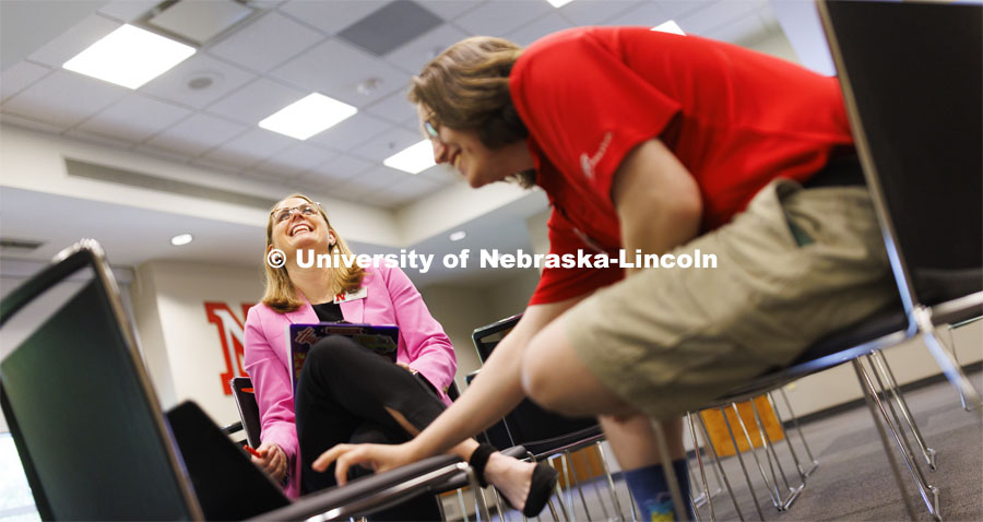 Jenni Brost, Director of New Student Enrollment, laughs as she and orientation leader Dalton Cooper review a video being planned for NSE. May 23, 2024. Photo by Craig Chandler / University Communication and Marketing.