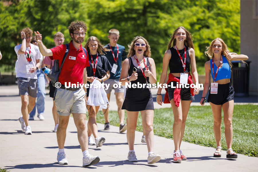 Jameson Margetts leads his group across campus to their next rotation. NSE New Student Enrollment. June 5, 2024. Photo by Craig Chandler / University Communication and Marketing.