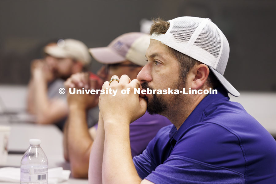 Nick Restau from Milford Public Schools listens as Travis Ray from Nebraska Innovation Studios goes over aviation charts. Ray is teaching drone classes so people can get their p107 license to fly. June 18, 2024. Photo by Craig Chandler / University Communication and Marketing.