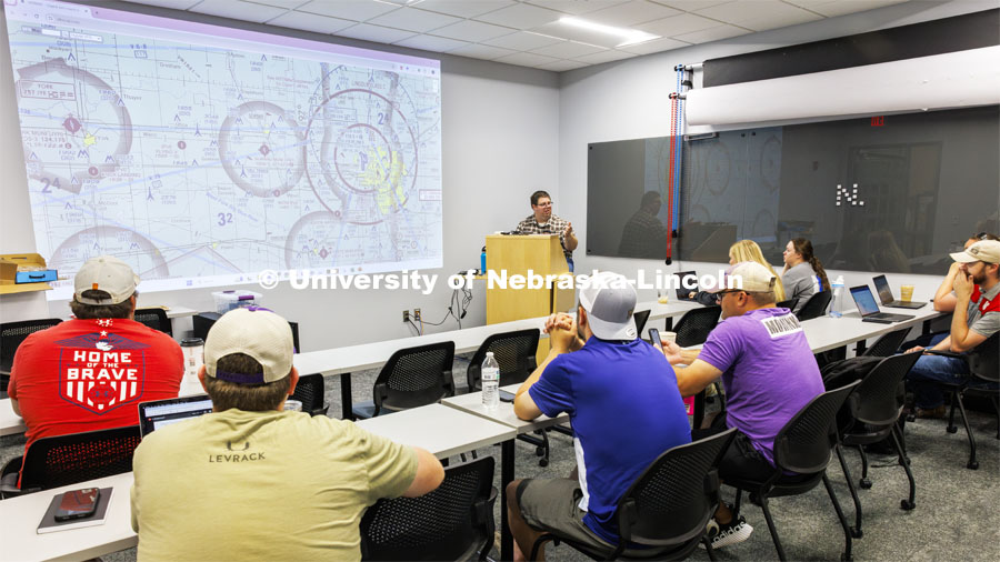 Travis Ray from Nebraska Innovation Studios dissects aeronautical sectional charts so the future drone pilots can learn where they can and can’t fly. Ray, from Nebraska Innovation Studios is teaching drone classes so people can get their p107 license to fly. June 18, 2024. Photo by Craig Chandler / University Communication and Marketing.