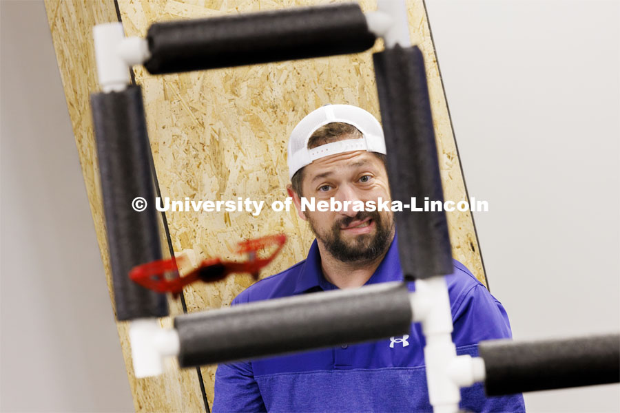 Concentration shows on Nick Restau’s face as he tries to pilot a small UAV through an obstacle course at Nebraska Innovation Studio. Restau, from Milford Public Schools, is one of several teachers training to get their drone license in a class taught by Travis Ray from Nebraska Innovation Studio. June 18, 2024. Photo by Craig Chandler / University Communication and Marketing.