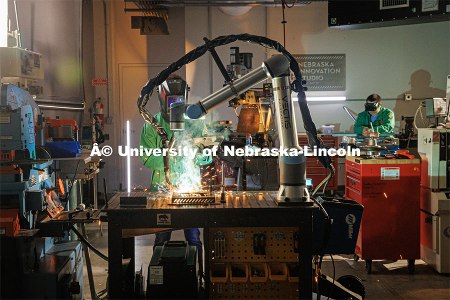 Filming Nebraska Innovation Studios welding robot. Behind the scenes photo for the university's new "Home Again" national advertisement. June 25, 2024. Photo by Kristen Labadie / University Communication.   