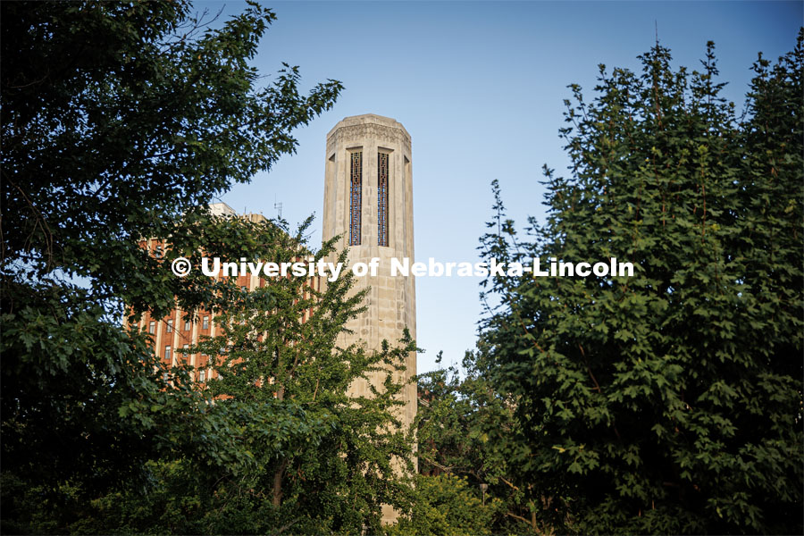 Mueller Bell Tower on city campus is framed by trees. On campus filming. Behind the scenes photo for the university's new "Home Again" national advertisement. June 25, 2024. Photo by Kristen Labadie / University Communication.   