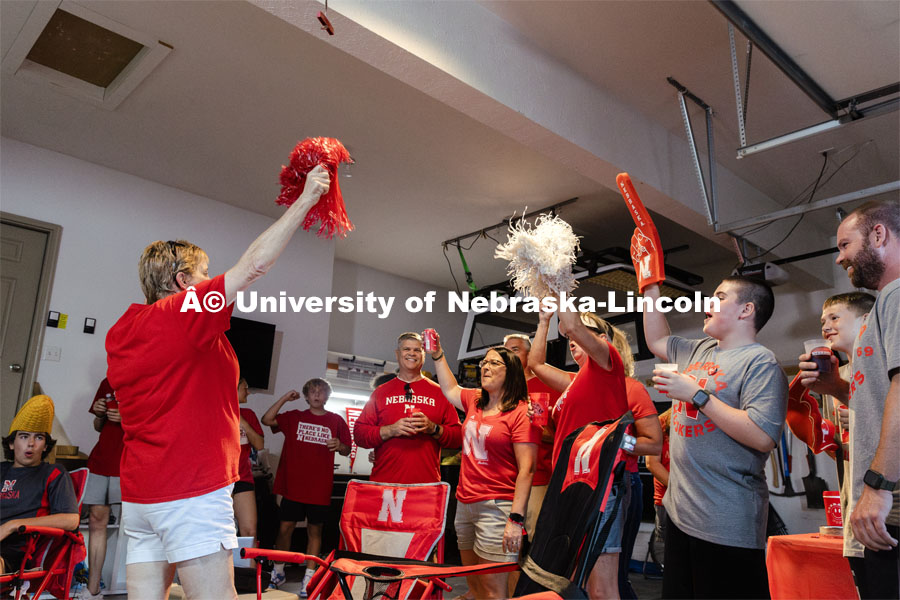 A film crew records a garage husker watch party in Omaha. Behind the scenes photo for the university's new "Home Again" national advertisement. June 26, 2024. Photo by Kristen Labadie / University Communication.   