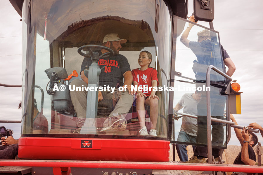 Filming a tractor in the field. Farming scenes. Behind the scenes photo for the university's new "Home Again" national advertisement. June 26, 2024. Photo by Kristen Labadie / University Communication.   