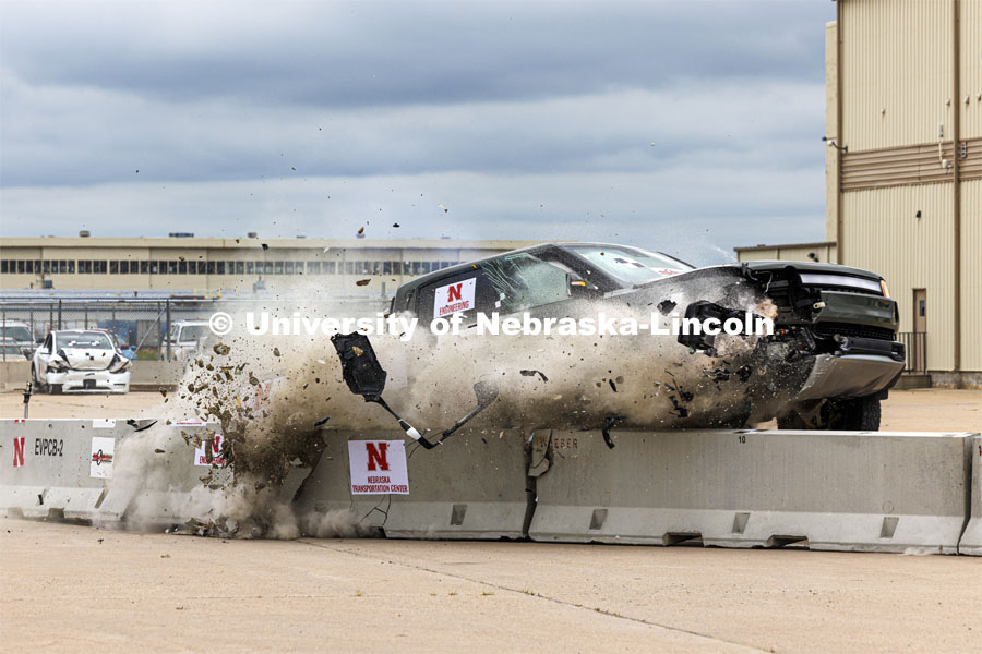 A Rivian R1T electric pickup crashes against a lane barrier during a crash test at the Midwest Roadside Safety Facility. Research sponsored by the U.S. Army Engineer Research and Development Center, the University of Nebraska-Lincoln’s Midwest Roadside Safety Facility is investigating the safety questions raised by the burgeoning number of electric vehicles on the nation’s roadways by performing crash test performed on a guardrail on At 62 mph, the 7,000-plus-pound, Rivian R1T truck crashed into a temporary barrier. The barrier deflected several feet but the truck did not go through the barrier. July 1, 2024. Photo by Craig Chandler / University Communication and Marketing.