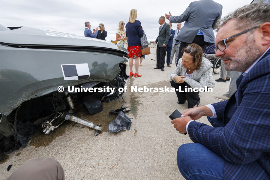 Senator Deb Fischer (R – Neb.), examines the crumpled front of the crashed Rivian R1T pickup truck. In research sponsored by the U.S. Army Engineer Research and Development Center, the University of Nebraska-Lincoln’s Midwest Roadside Safety Facility is investigating the safety questions raised by the burgeoning number of electric vehicles on the nation’s roadways by performing crash test performed on a guardrail at 62 mph, the 7,000-plus-pound, Rivian R1T truck crashed into a temporary barrier. The barrier deflected several feet but the truck did not go through the barrier. July 1, 2024. Photo by Craig Chandler / University Communication and Marketing.