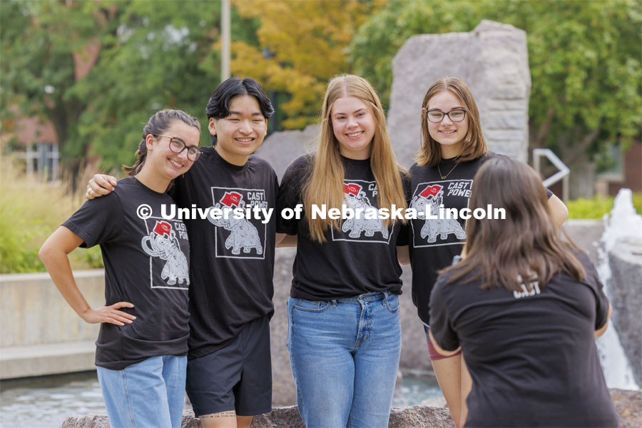 Sammy Smith, a senior in CoJMC, takes photos of CAST mentors in front of the Broyhill Fountain as they prepare for Sunday’s start of more than 300 new students in the program. City Campus. August 16, 2024. Photo by Craig Chandler / University Communication and Marketing.