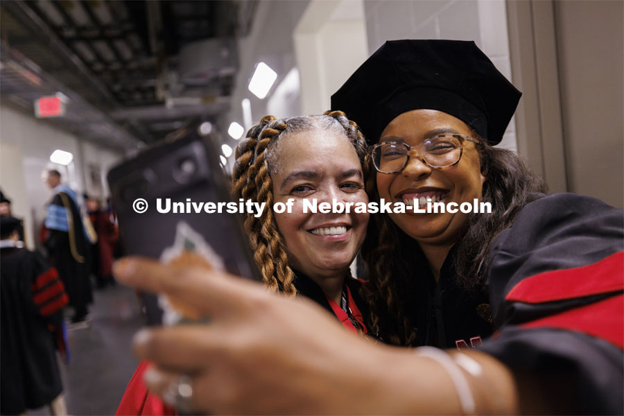 Genese Clark, right, takes a selfie with History Professor Dawn Curry before the Summer Commencement ceremony in Pinnacle Bank Arena. August 17, 2024. Photo by Craig Chandler / University Communication and Marketing.