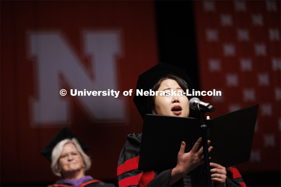 Sunmin Cha, a DMA Candidate, sings the national anthem. Summer Commencement ceremony in Pinnacle Bank Arena. August 17, 2024. Photo by Craig Chandler / University Communication and Marketing.