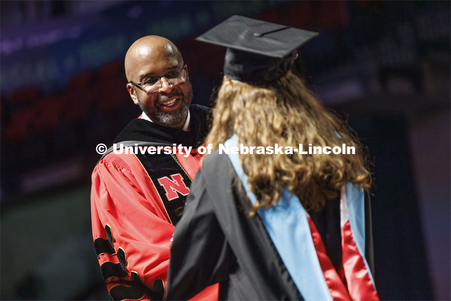 Chancellor Rodney D. Bennett congratulates a graduate. Summer Commencement ceremony in Pinnacle Bank Arena. August 17, 2024. Photo by Craig Chandler / University Communication and Marketing.