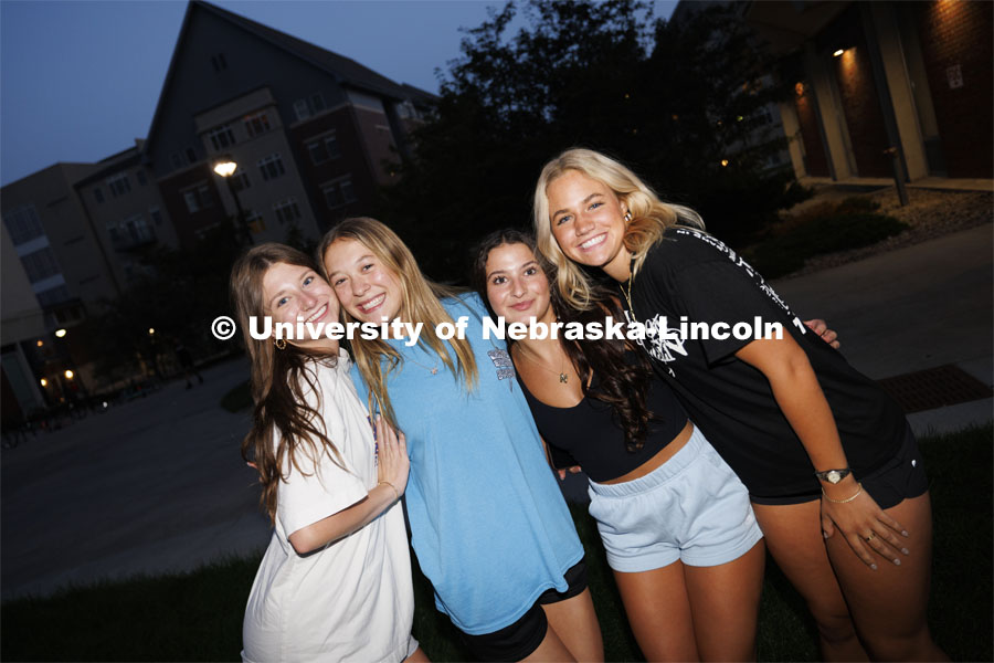 Four young ladies pose for a picture at the Block Party at Harper Schramm Smith residence halls. August 19, 2024. Photo by Craig Chandler / University Communication and Marketing.