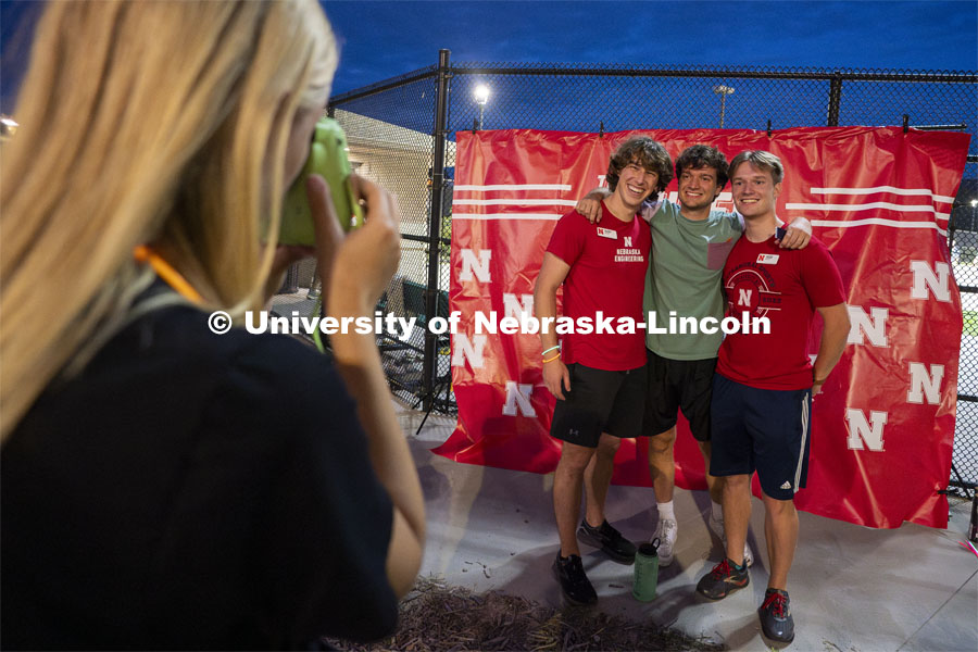 Seniors Liam O’Malley (left) Colin Safford (center), and Justin Kleen pose for a photo together during the Suites-Courtyards Block Party event. Big Red Welcome events. August 22, 2024. Photo by Jordan Opp for University Communication.