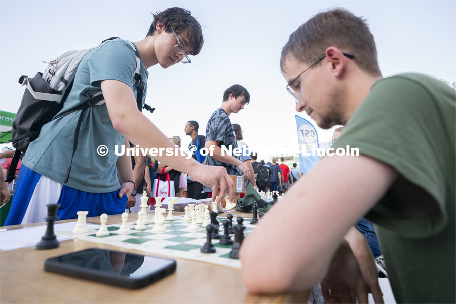 Freshman Alex Hernandez, left, plays chess against senior Andrew Cook at the Chess Club table during Big Red Welcome Street Fest on the Memorial Stadium loop. August 25, 2024. Photo by Jordan Opp for University Communication.