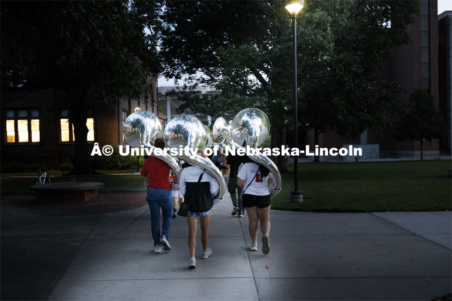 Band members walk to practice in the dark. Cornhusker Marching Band practice in Memorial Stadium. September 13, 2024. Photo by Craig Chandler / University Communication and Marketing.