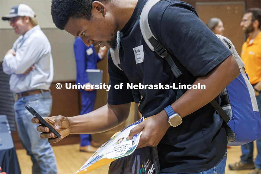 Oluwafunmibi Fasanya, a Statistics Graduate Student, snaps a picture of a QR code at the East Campus Career Fair. September 16, 2024. Photo by Kristen Labadie / University Communication.