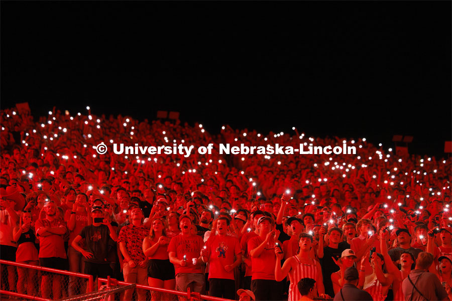 Fans illuminate a darkened stadium with their phone lights at the Nebraska vs. Illinois football game. September 20, 2024. Photo by Craig Chandler / University Communication and Marketing.