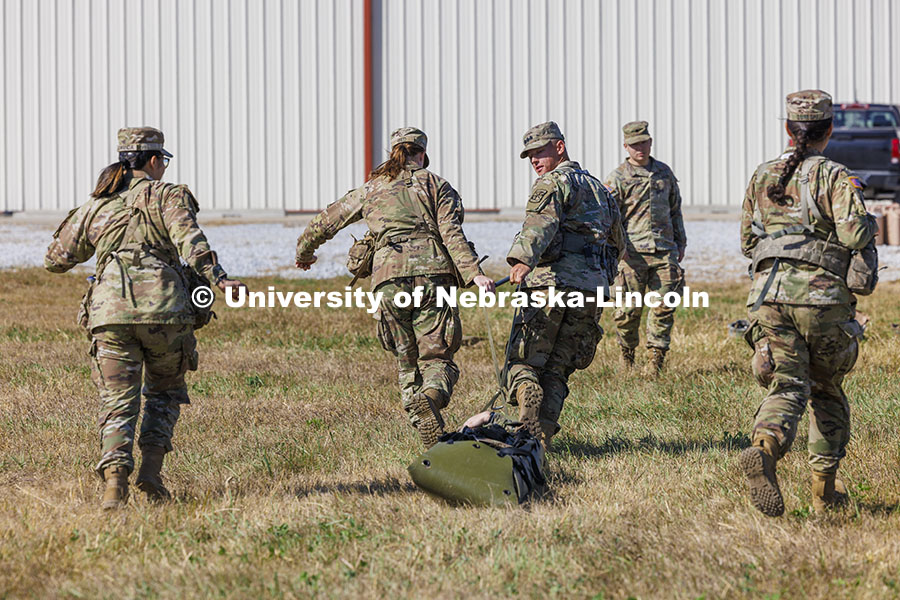 UNL cadet Max Holstrom looks back at a “wounded” soldier as the cadets pull a cadet on a sled to simulate helping and moving a wounded soldier. ROTC cadets on fall exercise. October 4, 2024. Photo by Craig Chandler / University Communication and Marketing.