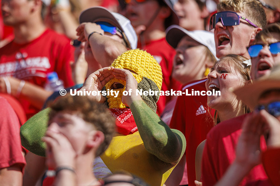 Ryan Jensen, a senior from Lincoln, wore his own version of a corn head knitted by his girlfriend, Emmy Oldham of Wellfleet, Nebraska. Jensen said it felt about 20 degrees hotter inside the headgear. Nebraska vs Rutgers football game. Homecoming game. October 5, 2024. Photo by Craig Chandler / University Communication and Marketing.