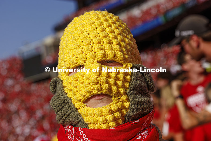 Ryan Jensen, a senior from Lincoln, wore his own version of a corn head knitted by his girlfriend, Emmy Oldham of Wellfleet, Nebraska. Jensen said it felt about 20 degrees hotter inside the headgear. Nebraska vs Rutgers football game. Homecoming game. October 5, 2024. Photo by Craig Chandler / University Communication and Marketing.