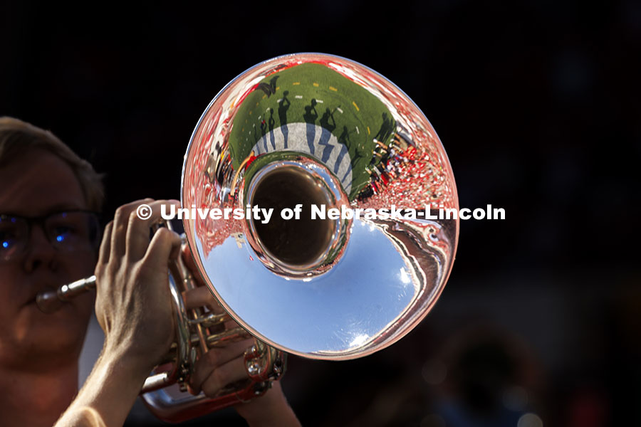 The stadium is reflected in the bell of a Cornhusker Marching Band instrument. Nebraska vs Rutgers football game. Homecoming game. October 5, 2024. Photo by Craig Chandler / University Communication and Marketing.