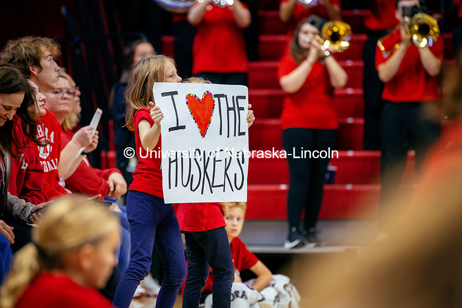 A child holds an I heart the Huskers sign at the Nebraska vs. Illinois Volleyball game. October 25, 2024. Photo by Kristen Labadie / University Communication.