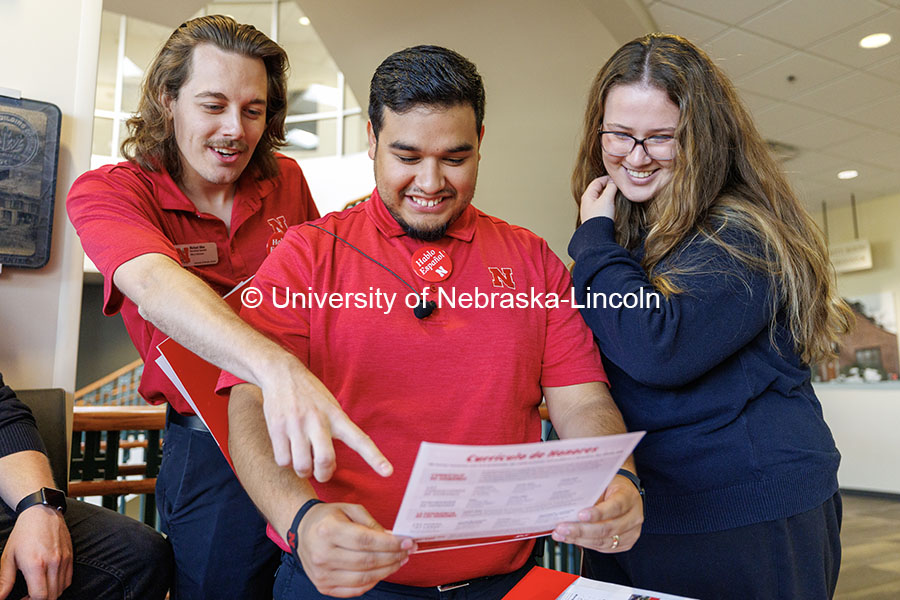 NSE student ambassadors Michael Allen (left), Jhovany Millan, and Ashleigh Welch look over a document they translated into Spanish during Spanish Visit Day. October 26, 2024. Photo by Jordan Opp / University Communication and Marketing.