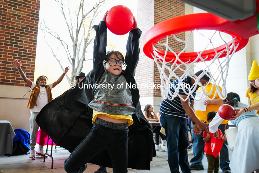 “Harry Potter” slam dunks a basketball at the Greek Street Trick or Treat. The University hosted a public Trick-or-Treat event at the chapter houses on Greek row. October 29, 2024. Photo by Vienna Oldenhof for University Communication and Marketing.