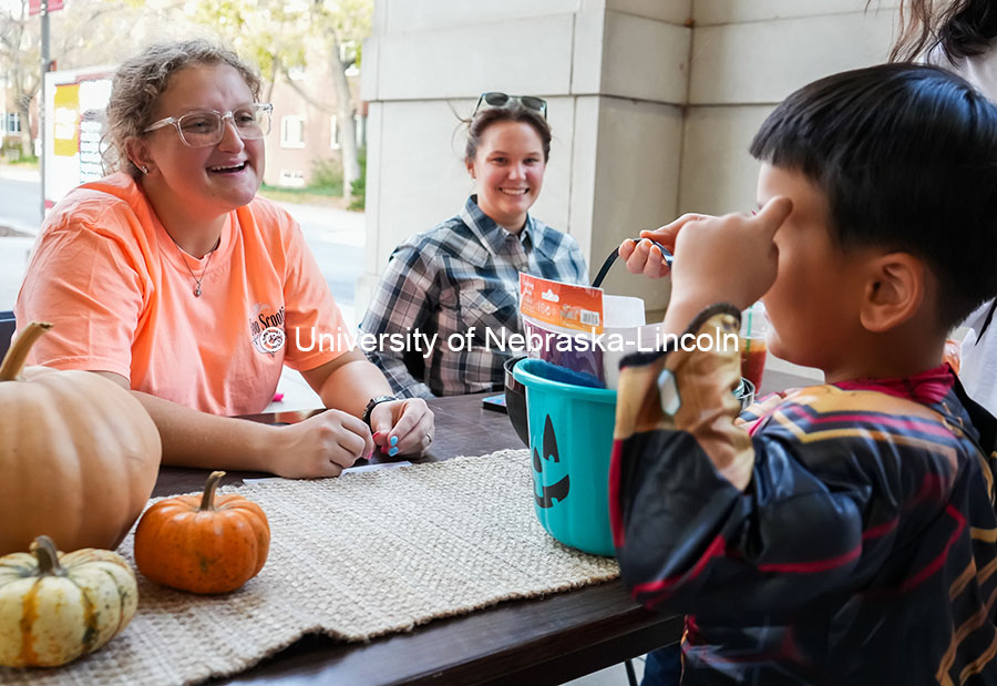 A little boy trick or treats at the Greek Street Trick or Treat. The University hosted a public Trick-or-Treat event at the chapter houses on Greek row. October 29, 2024. Photo by Vienna Oldenhof for University Communication and Marketing.