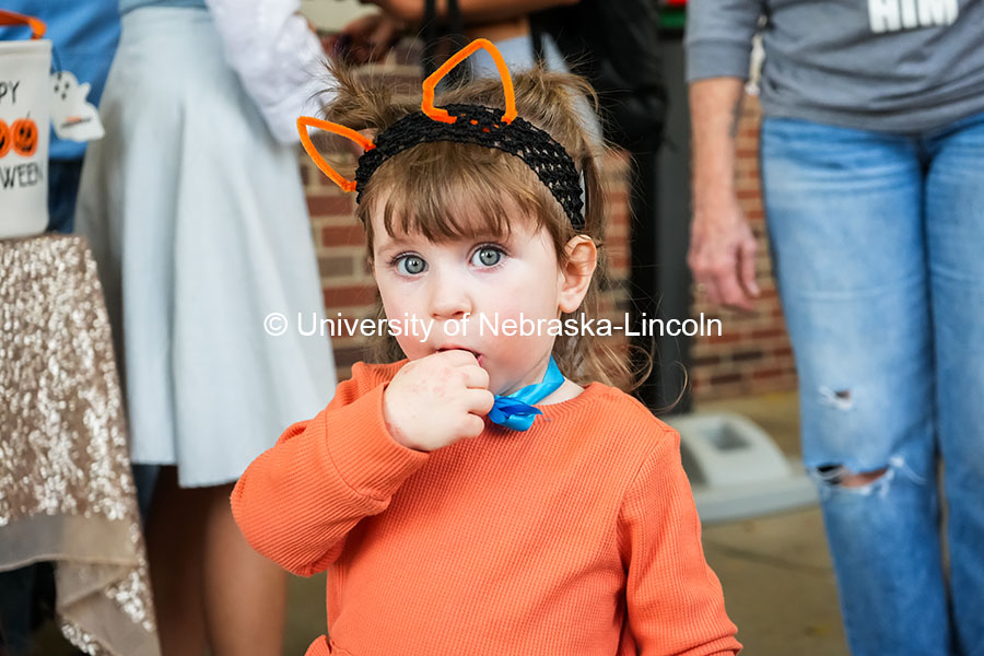 A little girl eats a piece of candy at the Greek Street Trick or Treat. The University hosted a public Trick-or-Treat event at the chapter houses on Greek row. October 29, 2024. Photo by Vienna Oldenhof for University Communication and Marketing.