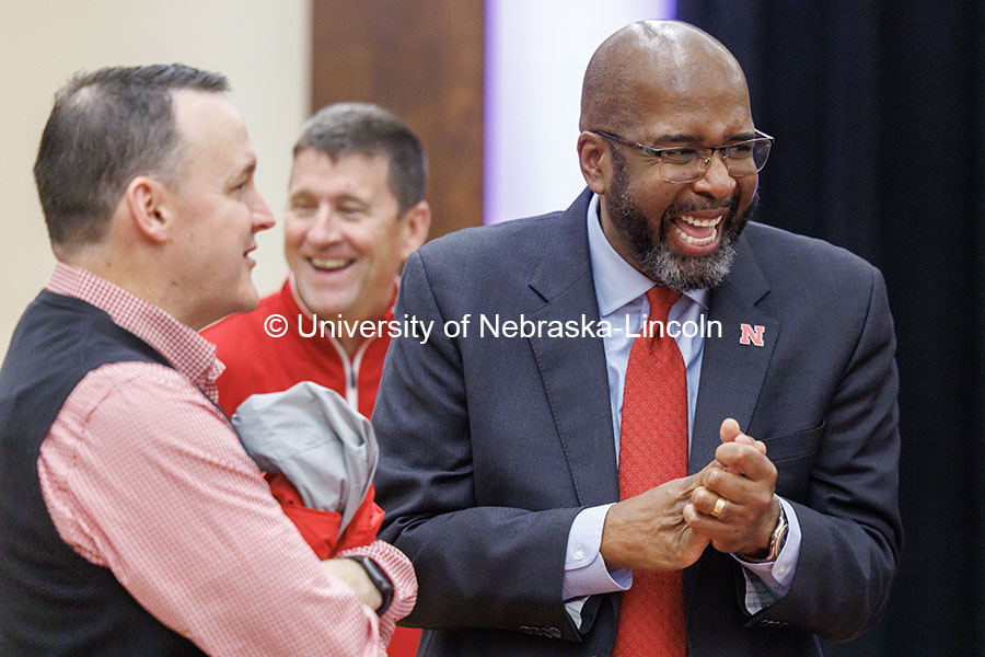 Chancellor Rodney Bennett, right, laughs as he talks to attendees of the Huddle Up Pre-Game Celebration inside the Nebraska Union Ballroom. Chancellor’s tailgate party.  November 2, 2024. Photo by Jordan Opp / University Communication and Marketing.