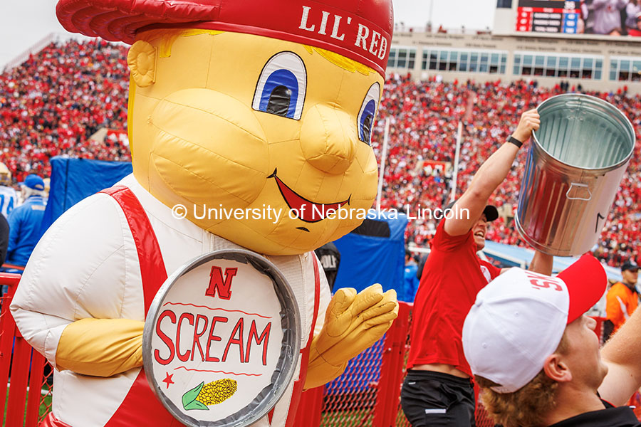 Lil Red holds a trash can lid saying “scream” at the Nebraska vs UCLA football game. November 2, 2024. Photo by Kristen Labadie / University Communication.