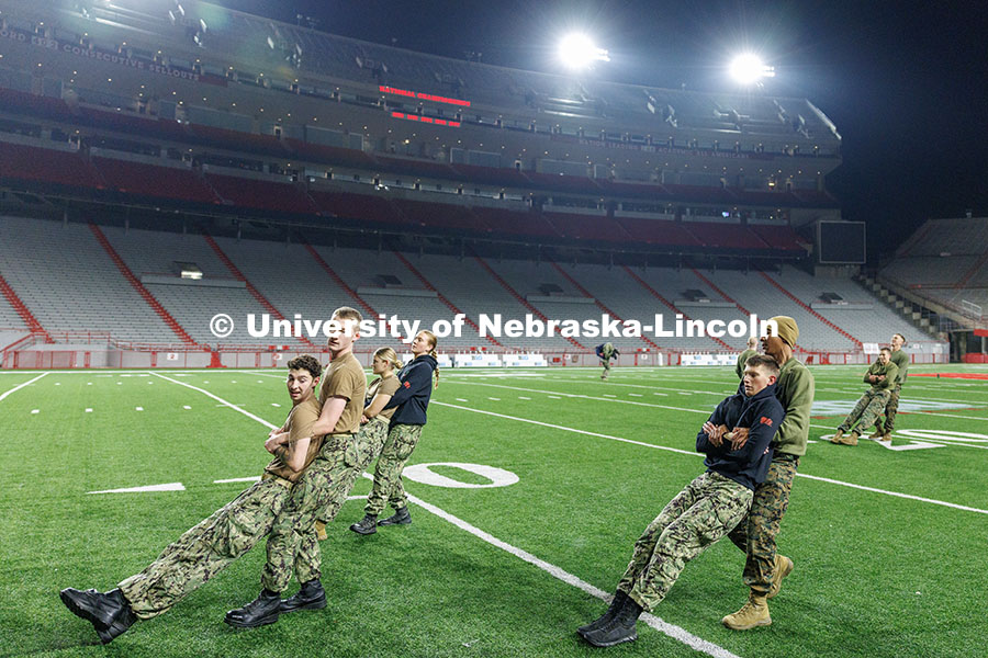 NROTC midshipmen preform buddy drags on the field. Navy and Marine Corps 249th birthday celebration physical training in Memorial Stadium. November 8, 2024. Photo by Jordan Opp / University Communication and Marketing.