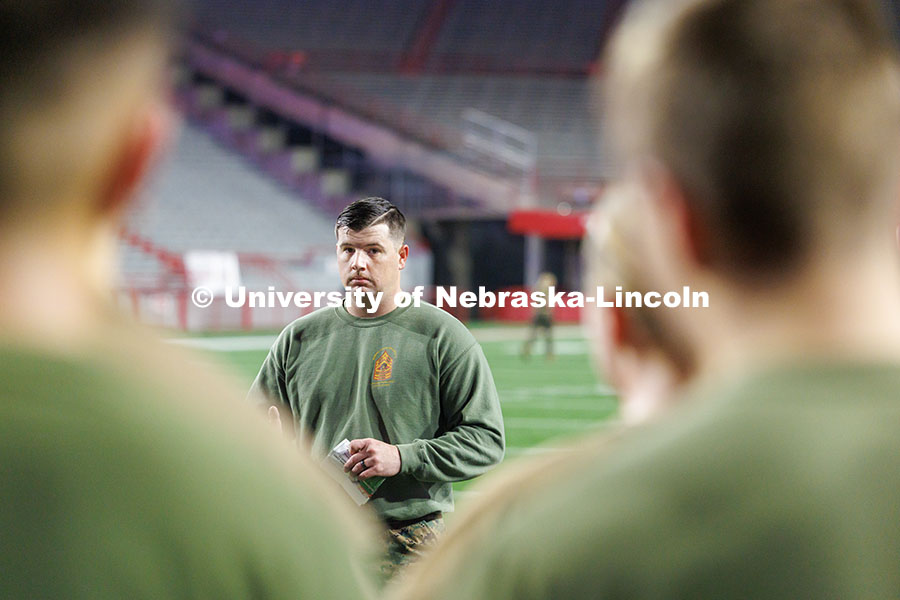 NROTC Staff Sergeant Dylon Taylor gives workout instructions to midshipmen. Navy and Marine Corps 249th birthday celebration physical training in Memorial Stadium. November 8, 2024. Photo by Jordan Opp / University Communication and Marketing.