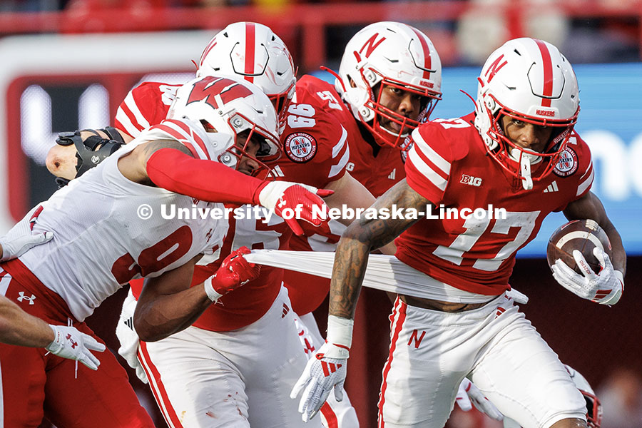 Wide receiver Jacory Barney Jr. (17) has his shirt pulled as he runs after catching the football for a first down. Nebraska vs. Wisconsin football game. November 23, 2024. Photo by Jordan Opp / University Communication and Marketing.