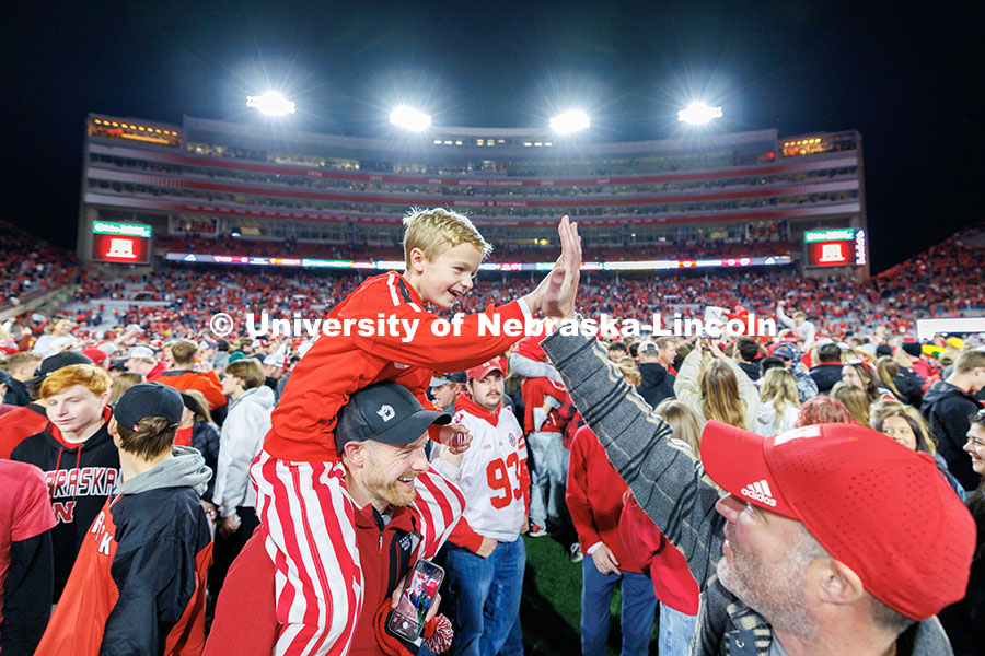 Husker fans storm the field following the team’s 44-25 win over Wisconsin to secure bowl game eligibility. Nebraska vs. Wisconsin football game. November 23, 2024. Photo by Jordan Opp / University Communication and Marketing.