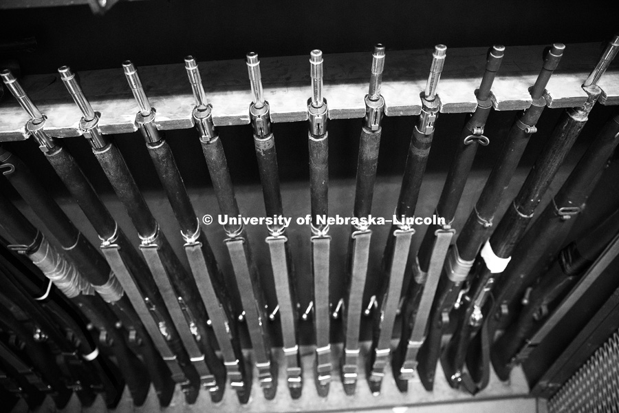 The Springfield rifles rest in their rack following practice. Pershing Rifle drill team practices in