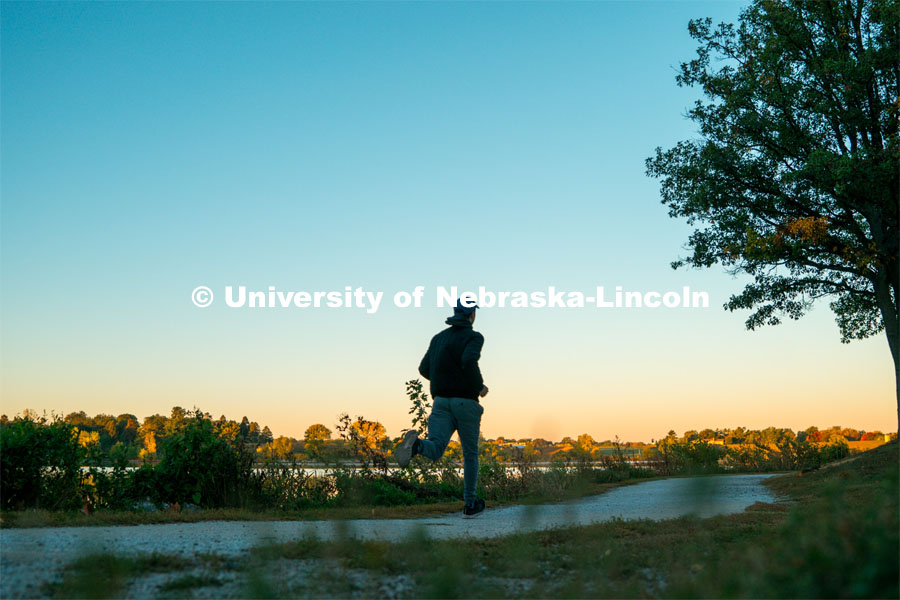 A jogger runs the walking path at Holmes Lake. About Lincoln at Holmes Lake. October 20, 2023. 