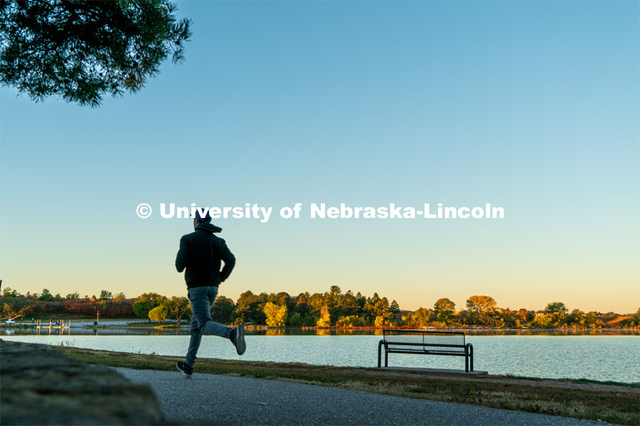 A jogger runs the walking path at Holmes Lake. About Lincoln at Holmes Lake. October 20, 2023. 