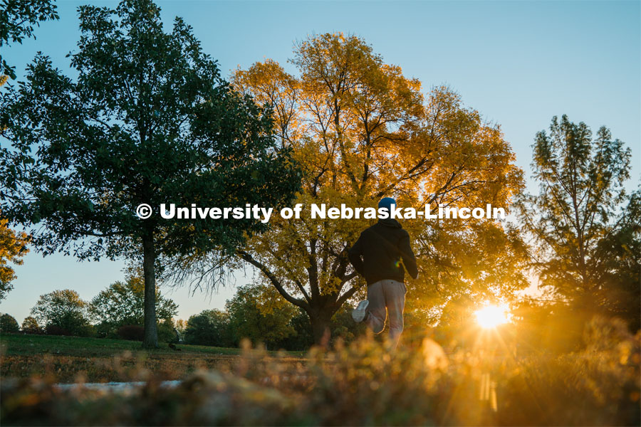 A jogger runs the walking path at Holmes Lake. About Lincoln at Holmes Lake. October 20, 2023. 