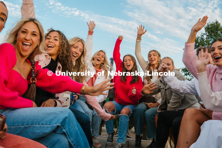 Members of the Husker Cheer Squad on a hay rack ride at Roca Berry Farm. About Lincoln at Roca Berry