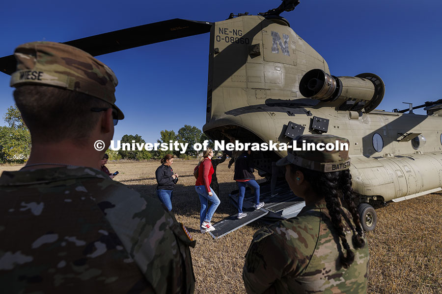 UNL advisors and professors board the CH-47D Chinook helicopter to observe the ROTC cadets on fall e