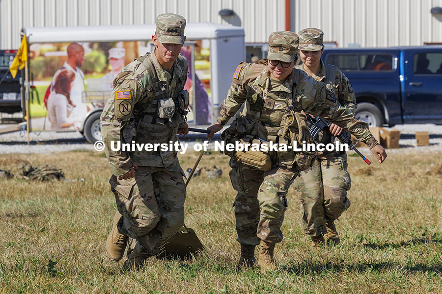 UNL cadet Max Holstrom, left, and Creighton cadet Mariska Suwanda pull a cadet on a sled to simulate