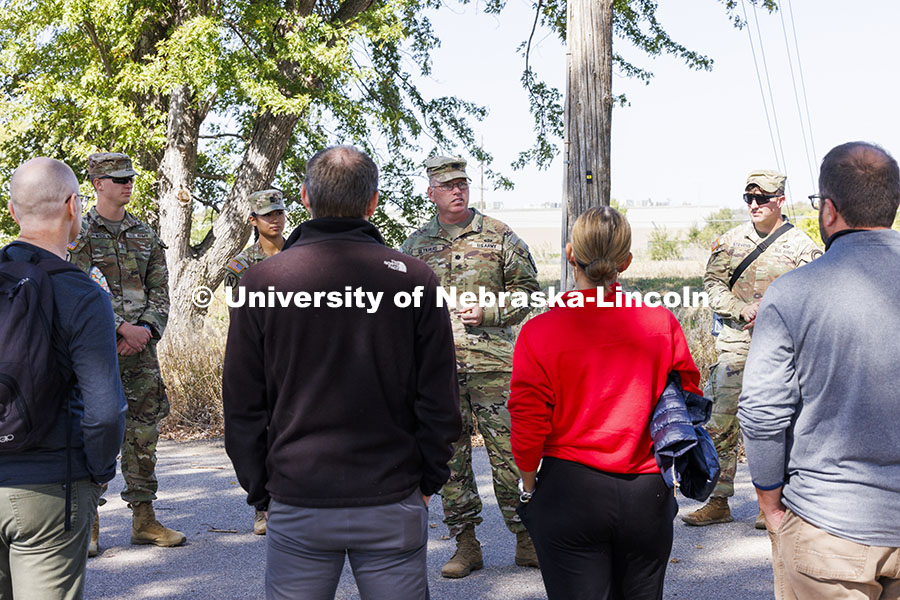 Lt. Col. Tom Slykhuis talks to the professors and staff members as cadets, from left, Joe Wiese, Aly