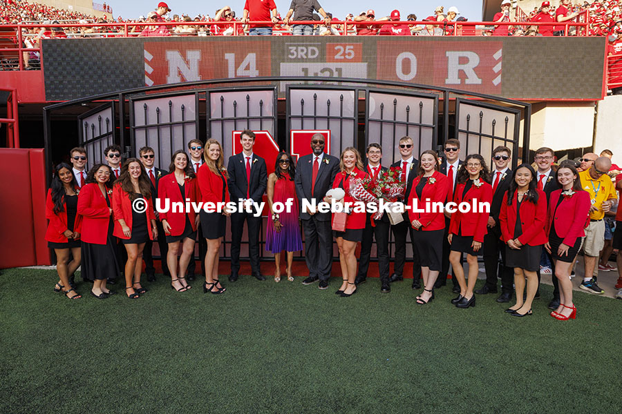 UNL Chancellor Rodney D. Bennett and his wife, Temple, pose with the 2024 Homecoming Court. Nebraska