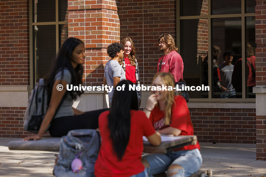 Viraj Karthik, Nick Coldiron, and Kate McKinzie talk outside the Raikes school as they enjoy the fal