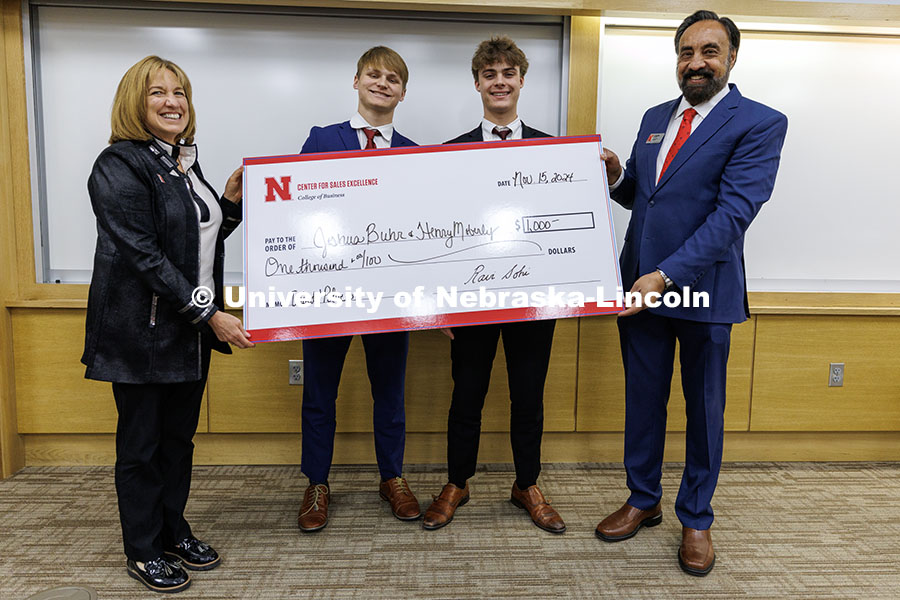 Joshua Buhr and Henry Moberly, center, stand with their third-place check. Fall 2024 Center for Sale