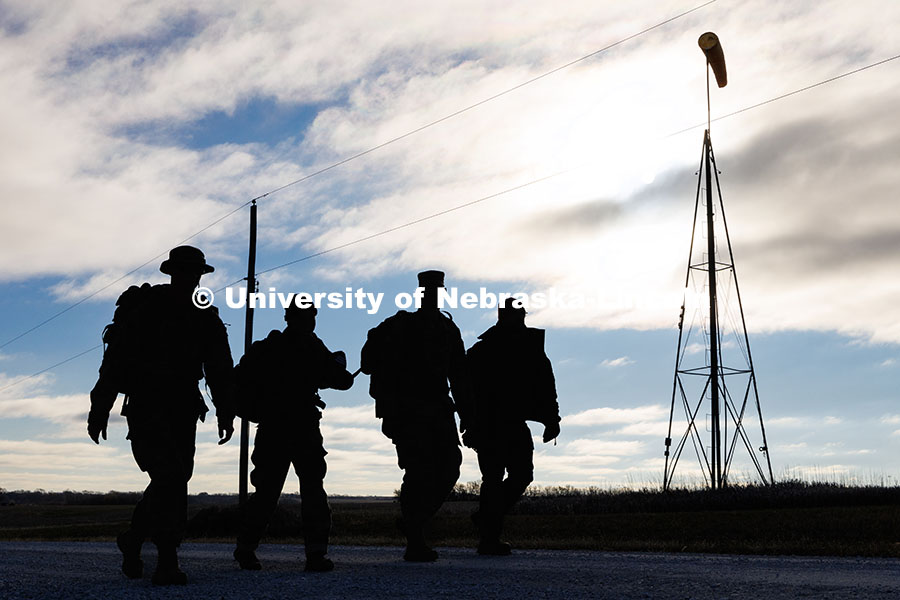 Army ROTC cadets Joe Wiese (from left) Malorie Mulligan, and Max Holmstrom, walk alongside Nebraska 