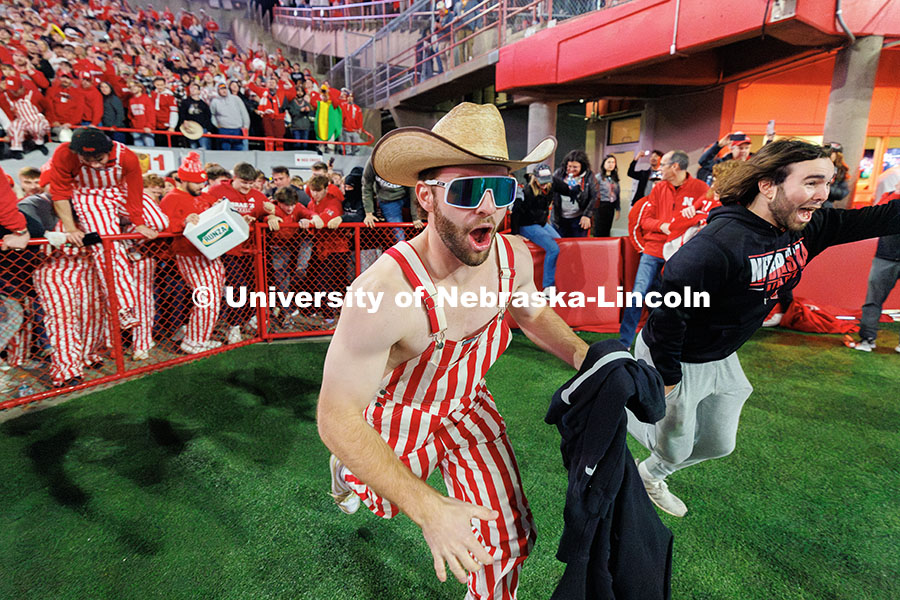 Husker fans storm the field following the team’s 44-25 win over Wisconsin to secure bowl game elig