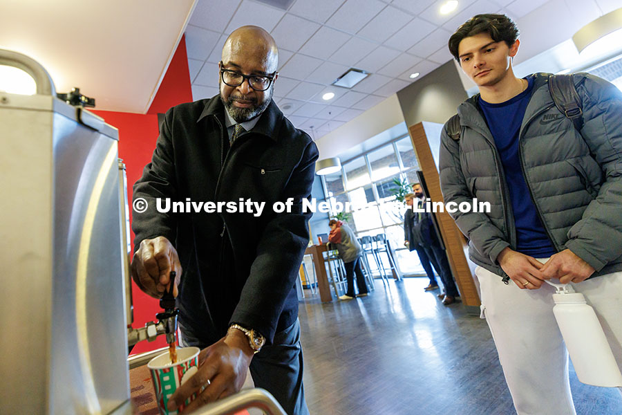 Chancellor Rodney Bennett, left, serves coffee to students inside the Nebraska Union. Finals Fuel. D